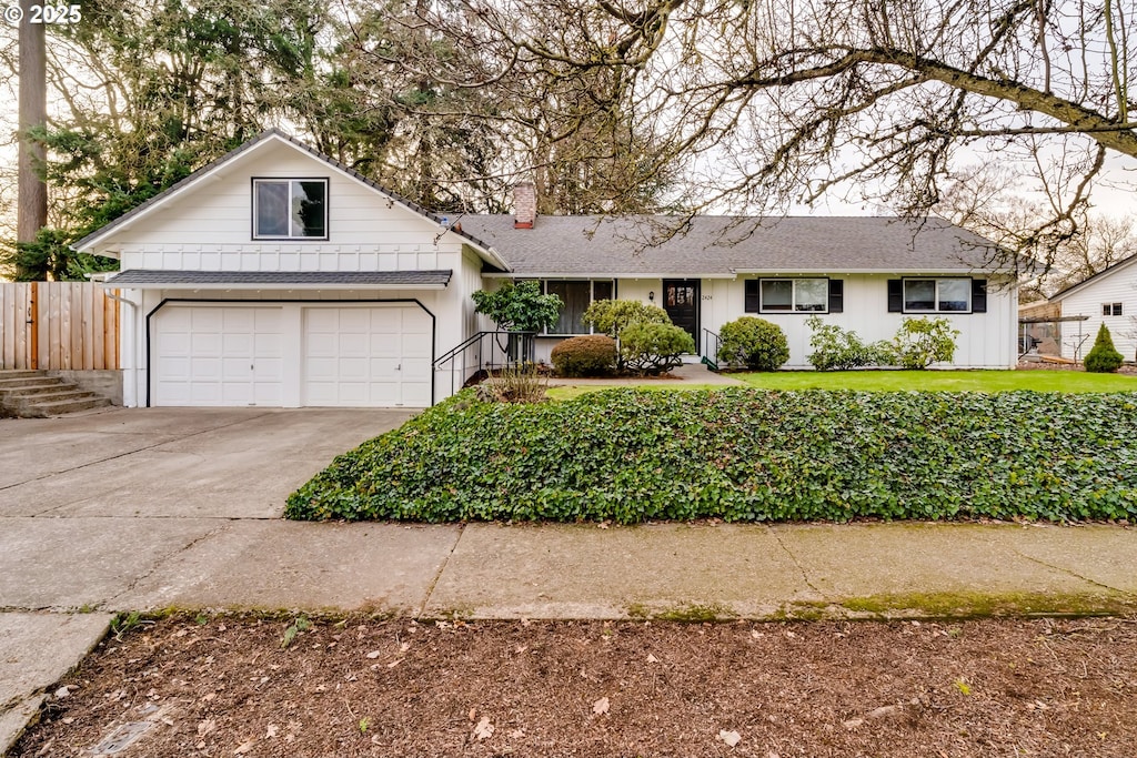 single story home with a garage and a front yard