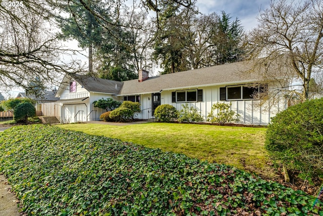 ranch-style house featuring a garage and a front lawn