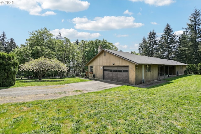 view of home's exterior with a lawn, a garage, aphalt driveway, and a chimney