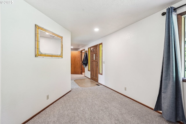 unfurnished room with recessed lighting, carpet, and baseboards