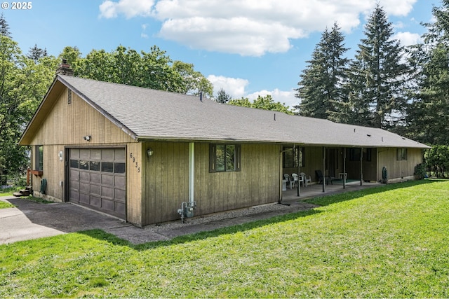 view of front of home featuring driveway, a chimney, roof with shingles, a front yard, and a garage