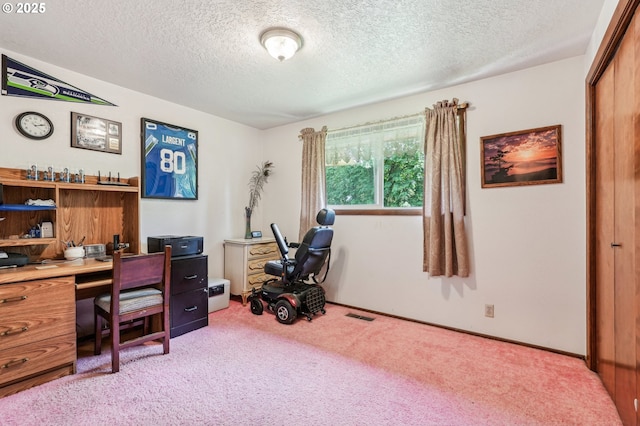 home office featuring a textured ceiling, visible vents, and carpet