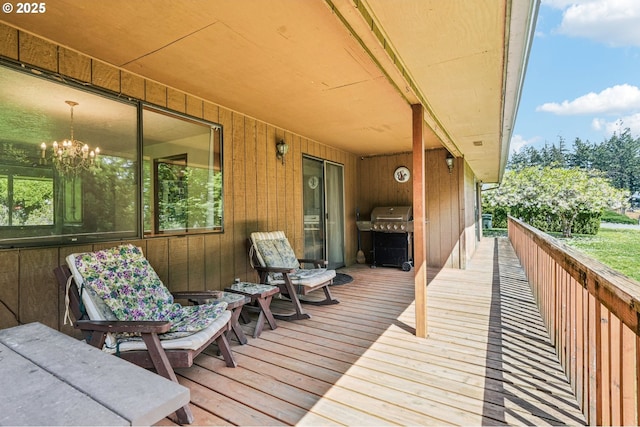 wooden terrace featuring a grill