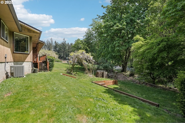 view of yard featuring stairs and central AC