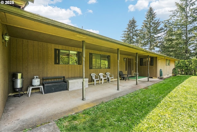 rear view of house featuring a patio area and a yard