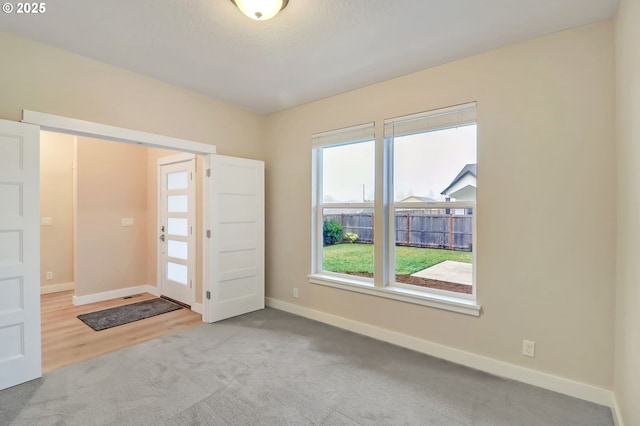 foyer entrance with light carpet