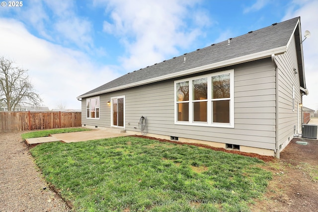 back of property with a yard, central AC, and a patio area