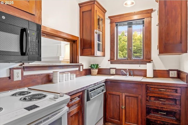 kitchen featuring black microwave, a sink, glass insert cabinets, dishwashing machine, and white electric range