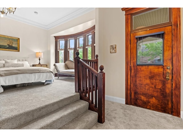 carpeted bedroom featuring baseboards and ornamental molding
