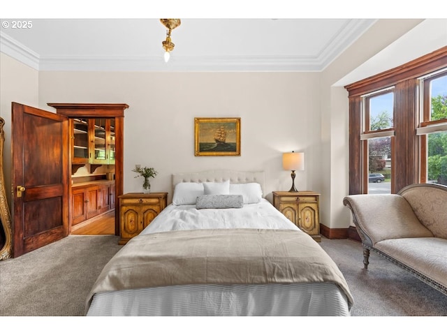 carpeted bedroom featuring baseboards and ornamental molding