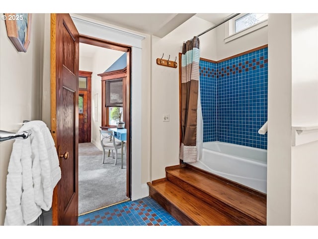 full bath featuring tile patterned floors and shower / bathtub combination with curtain