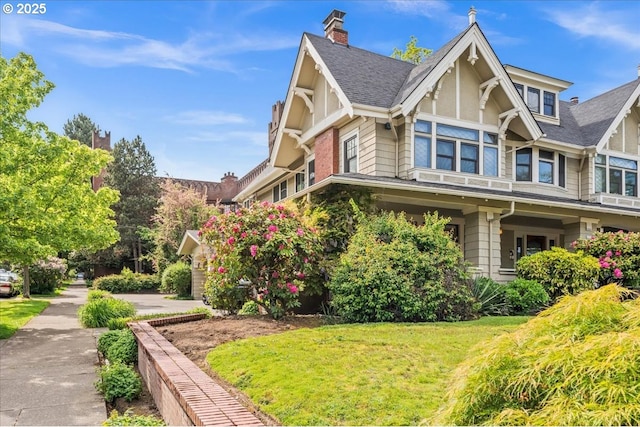 1111 NW 25th Ave Unit 1, Portland, OR 97210 - view of home's exterior featuring a chimney and a yard