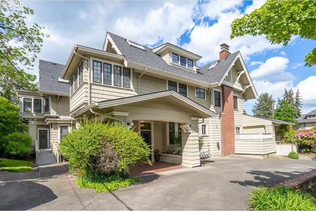 1111 NW 25th Ave Unit 1, Portland, OR 97210 - view of front of home with a shingled roof, a chimney, and driveway