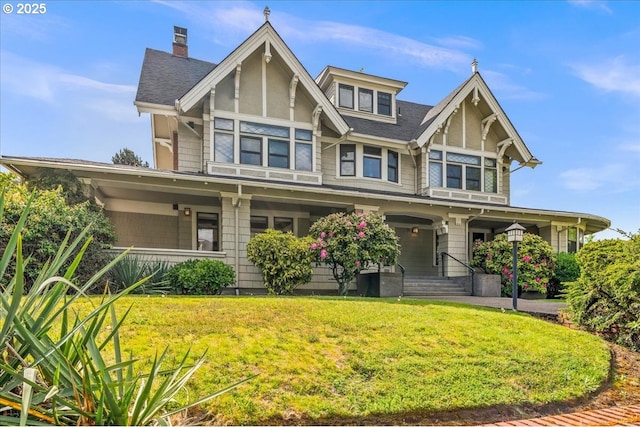1111 NW 25th Ave Unit 1, Portland, OR 97210 - view of front facade featuring a porch, a front lawn, and a shingled roof