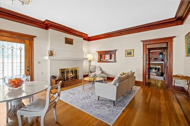 1111 NW 25th Ave Unit 1, Portland, OR 97210 - living area with a fireplace with flush hearth, crown molding, wood-type flooring, and baseboards
