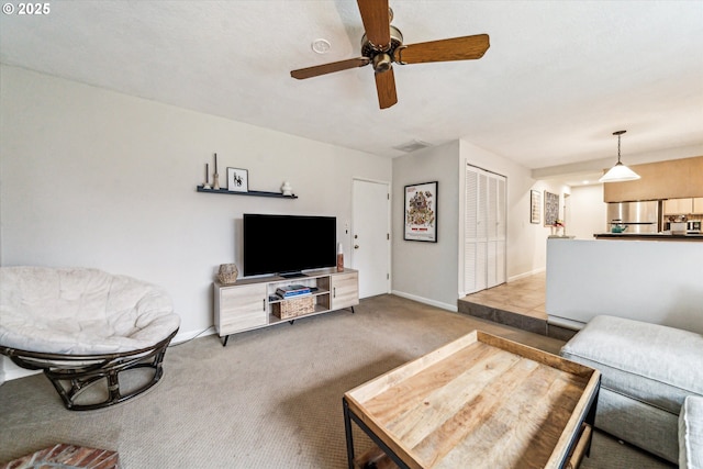 living room with ceiling fan and carpet floors