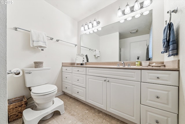 bathroom featuring vanity, tile patterned floors, and toilet