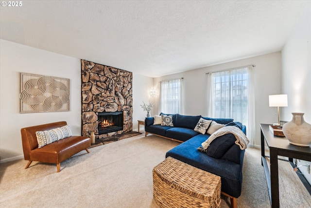 carpeted living room featuring a textured ceiling and a fireplace