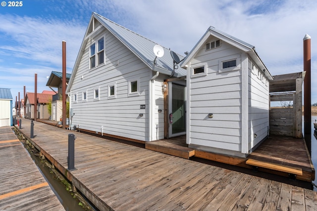 rear view of house featuring metal roof