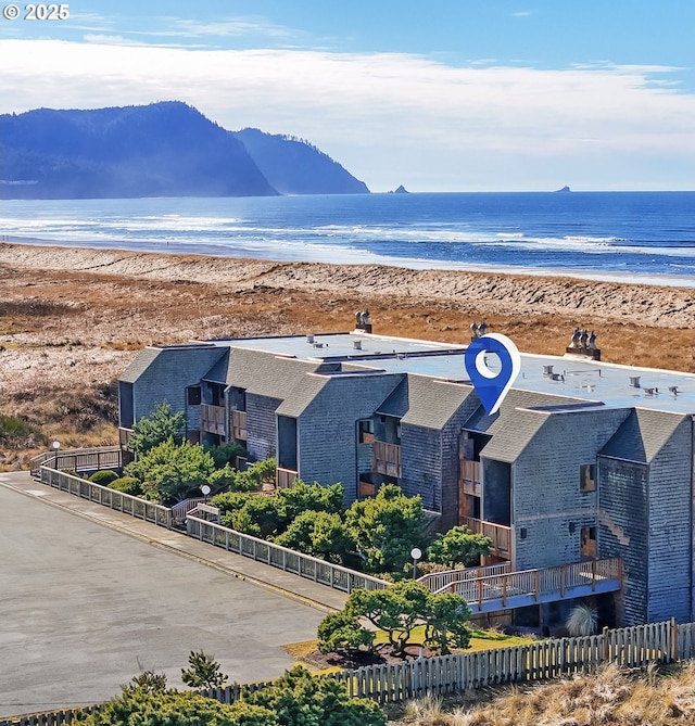 aerial view with a water view and a beach view