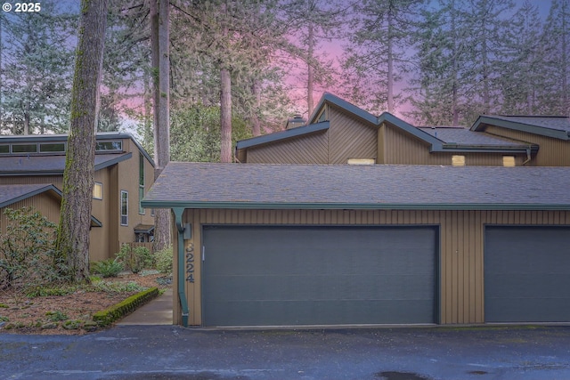 view of garage at dusk