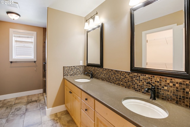 13577 SE Kisor Ct, Happy Valley, OR 97086 - bathroom featuring tasteful backsplash, baseboards, double vanity, and tile patterned flooring