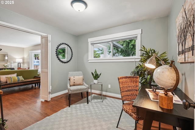 office area featuring baseboards and wood finished floors