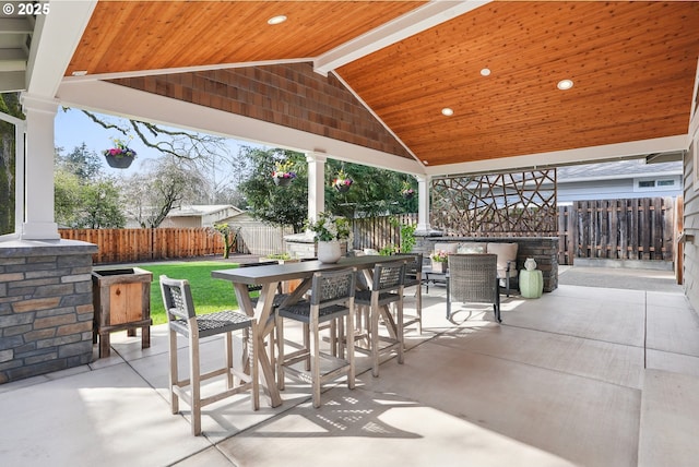 view of patio featuring outdoor dining area and fence