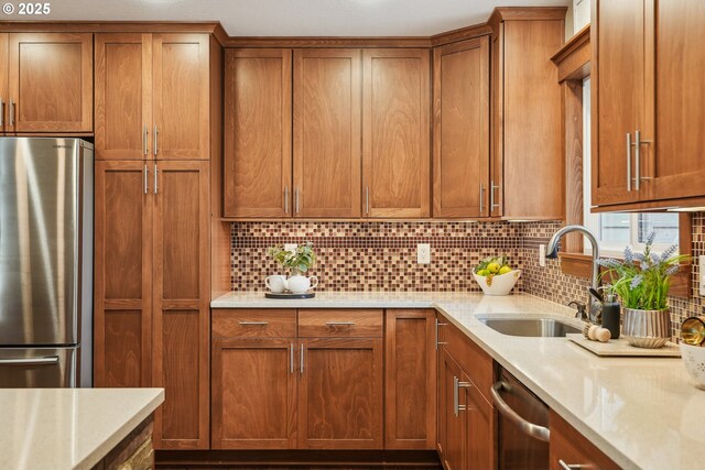 kitchen featuring a sink, stainless steel appliances, backsplash, and brown cabinetry