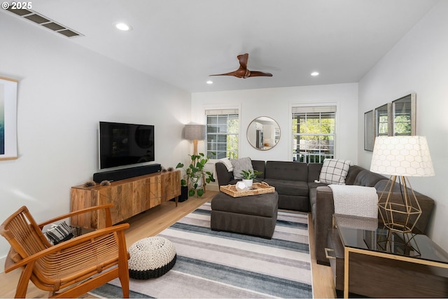 living room featuring wood finished floors, visible vents, and recessed lighting
