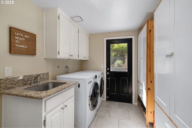 laundry room featuring washing machine and dryer, cabinet space, a sink, and light tile patterned flooring