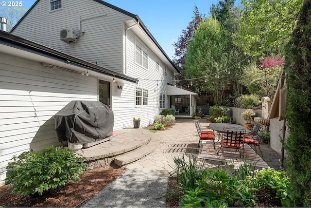 back of house with outdoor dining space, ac unit, and a patio