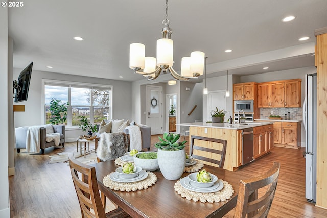3985 SE Lostine Ln, Hillsboro, OR 97123 - dining area featuring light wood finished floors, recessed lighting, and a chandelier