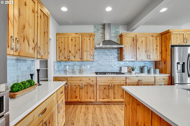 3985 SE Lostine Ln, Hillsboro, OR 97123 - kitchen featuring wall chimney exhaust hood, appliances with stainless steel finishes, light wood finished floors, backsplash, and recessed lighting