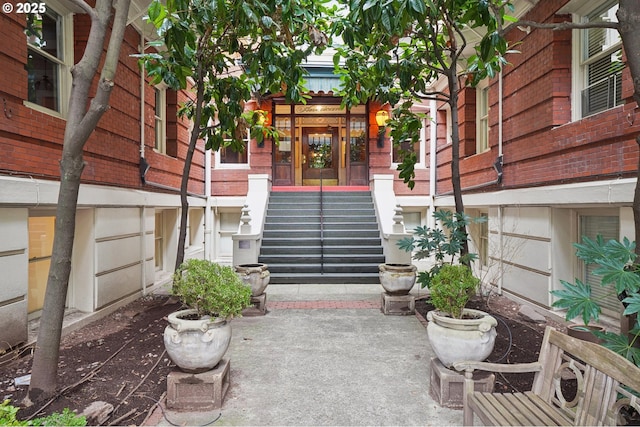 view of exterior entry featuring brick siding