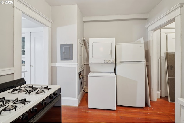 laundry room with stacked washing maching and dryer, electric panel, light wood finished floors, and laundry area