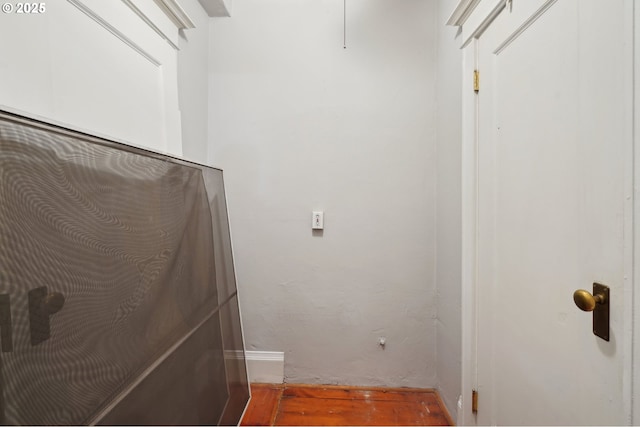 washroom featuring baseboards and wood finished floors
