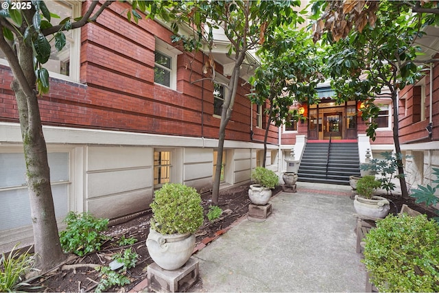 view of home's exterior featuring a patio and stairway