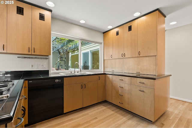 kitchen featuring a sink, dark countertops, light wood-style floors, and dishwasher