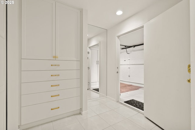 walk in closet with light tile patterned floors