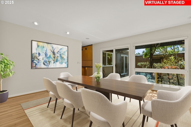 dining space with recessed lighting, baseboards, and light wood-type flooring