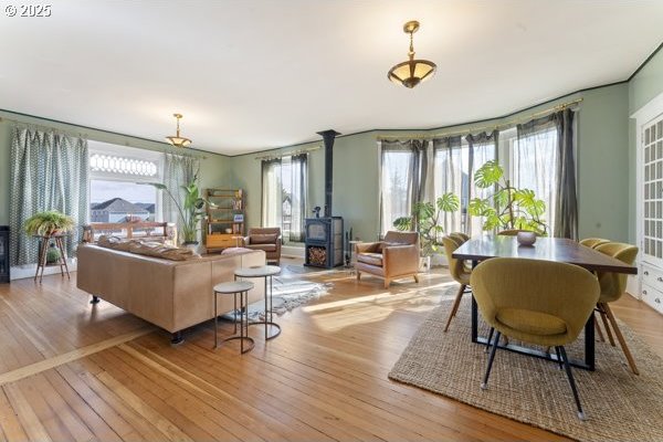 1508 Union Ave, North Bend, OR 97459 - living room with a wood stove, wood finished floors, and healthy amount of natural light