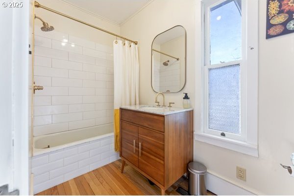 1508 Union Ave, North Bend, OR 97459 - full bath with vanity, tiled shower / bath combo, wood finished floors, and ornamental molding