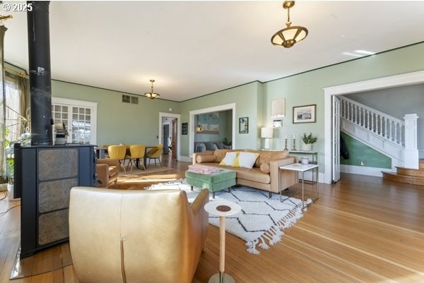 1508 Union Ave, North Bend, OR 97459 - living area featuring a wood stove, wood finished floors, and stairs