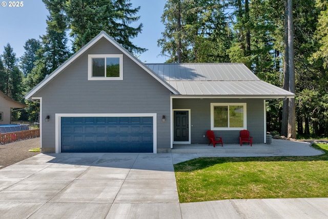 48438 E Meadow Way, Oakridge, OR 97463 - view of front of home with a porch, driveway, a front lawn, and an attached garage
