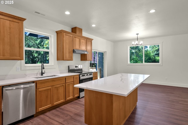 48438 E Meadow Way, Oakridge, OR 97463 - kitchen with appliances with stainless steel finishes, under cabinet range hood, dark wood-style flooring, recessed lighting, and a chandelier