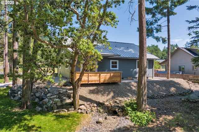 48438 E Meadow Way, Oakridge, OR 97463 - rear view of house with a deck, a metal roof, a standing seam roof, and crawl space