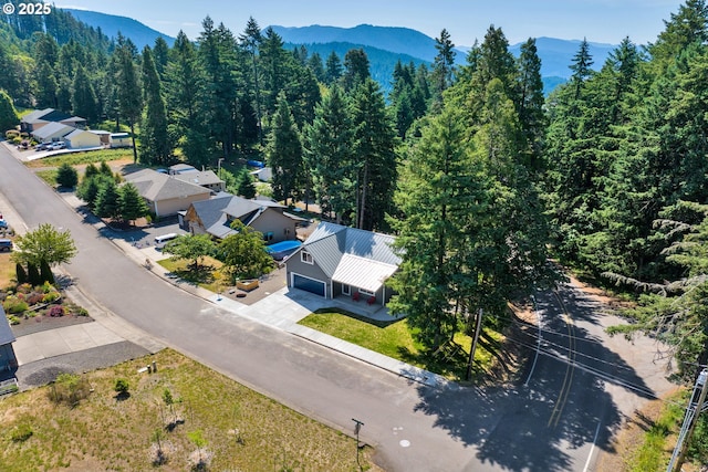 48438 E Meadow Way, Oakridge, OR 97463 - aerial view of property and surrounding area featuring a forest and a mountainous background
