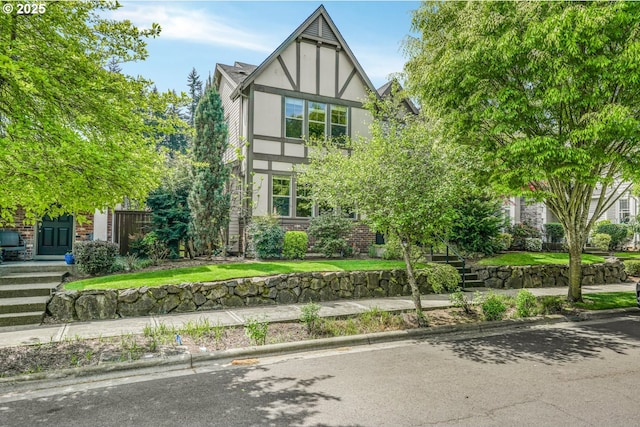 tudor-style house featuring stucco siding