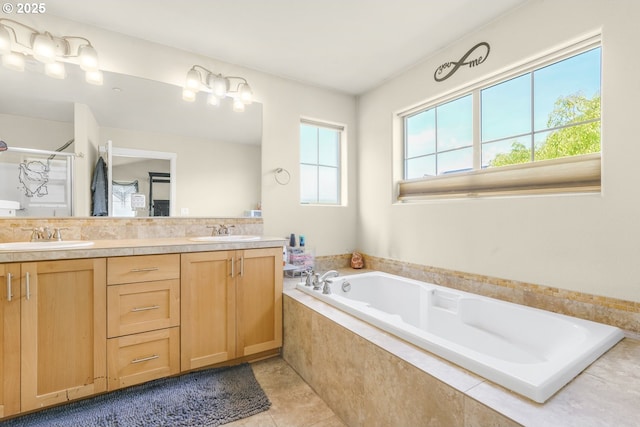 full bath with a sink, tile patterned floors, a garden tub, and double vanity